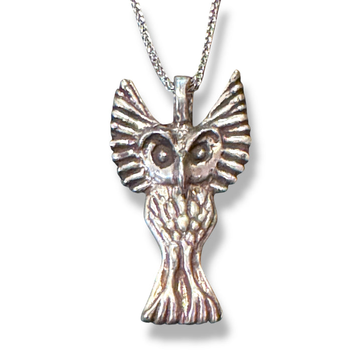 silver owl on silver chain on white background