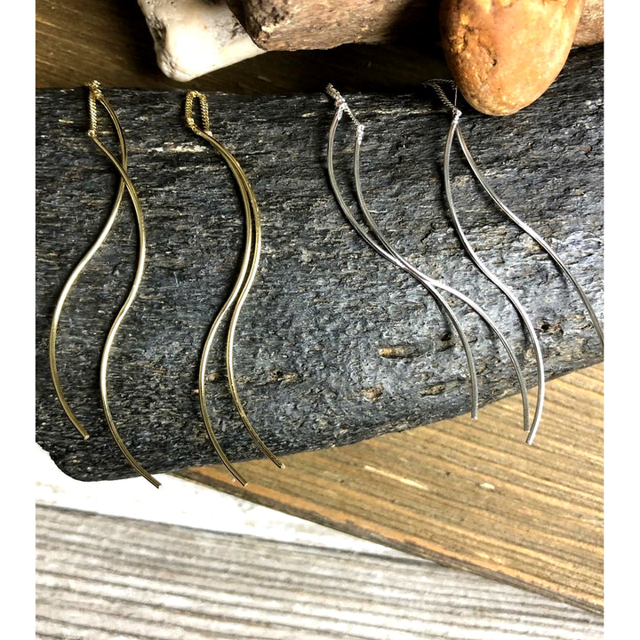 double helix threader earrings displayed on fossil bone in silver and gold