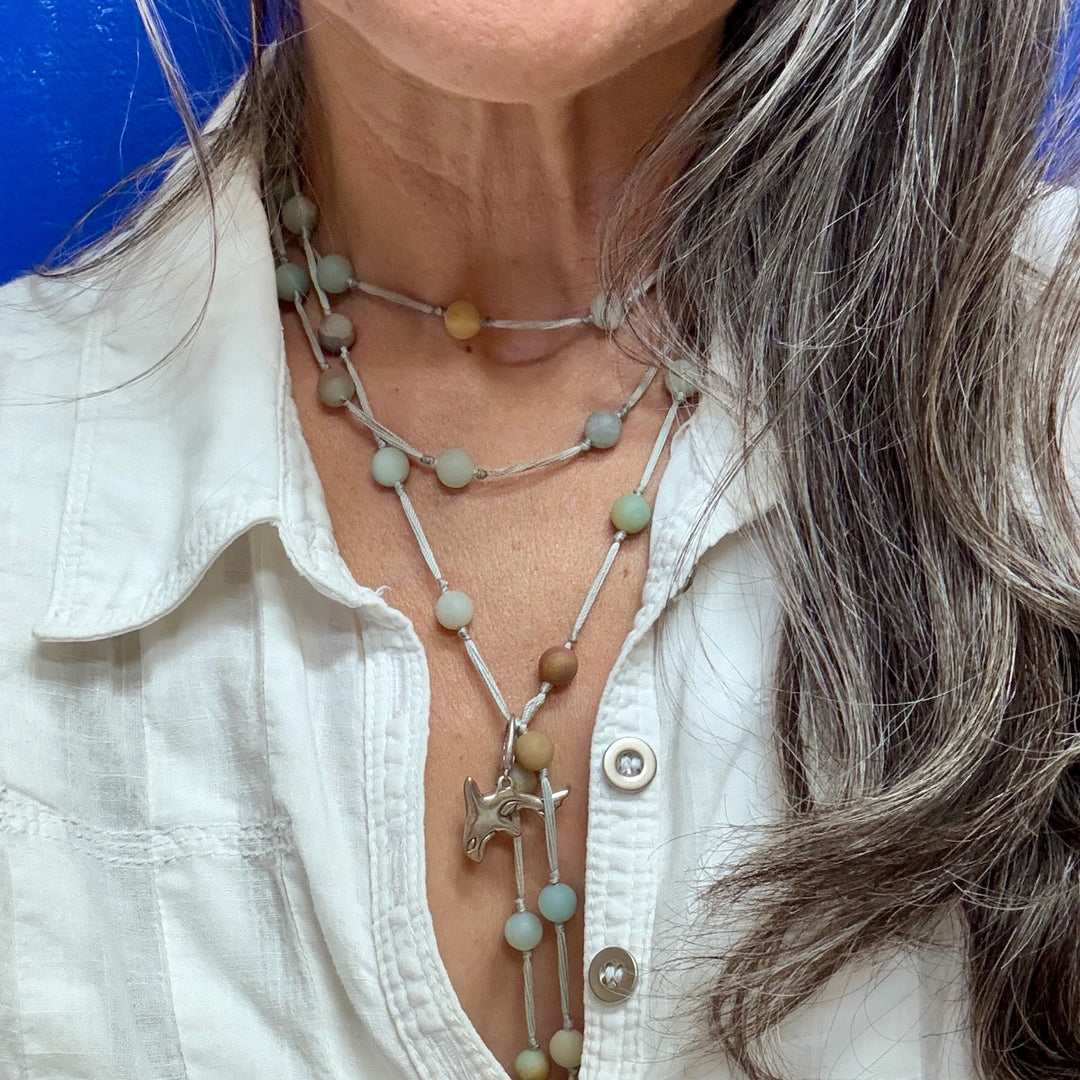 woman wearing backbeads with orca charm