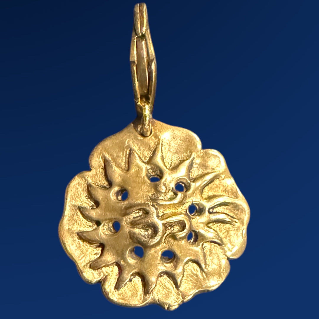 om lotus flower bronze charm on blue background