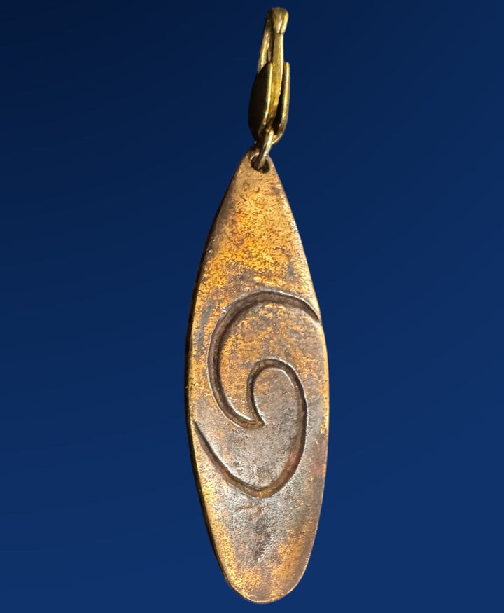 bronze surfboard charm on blue background
