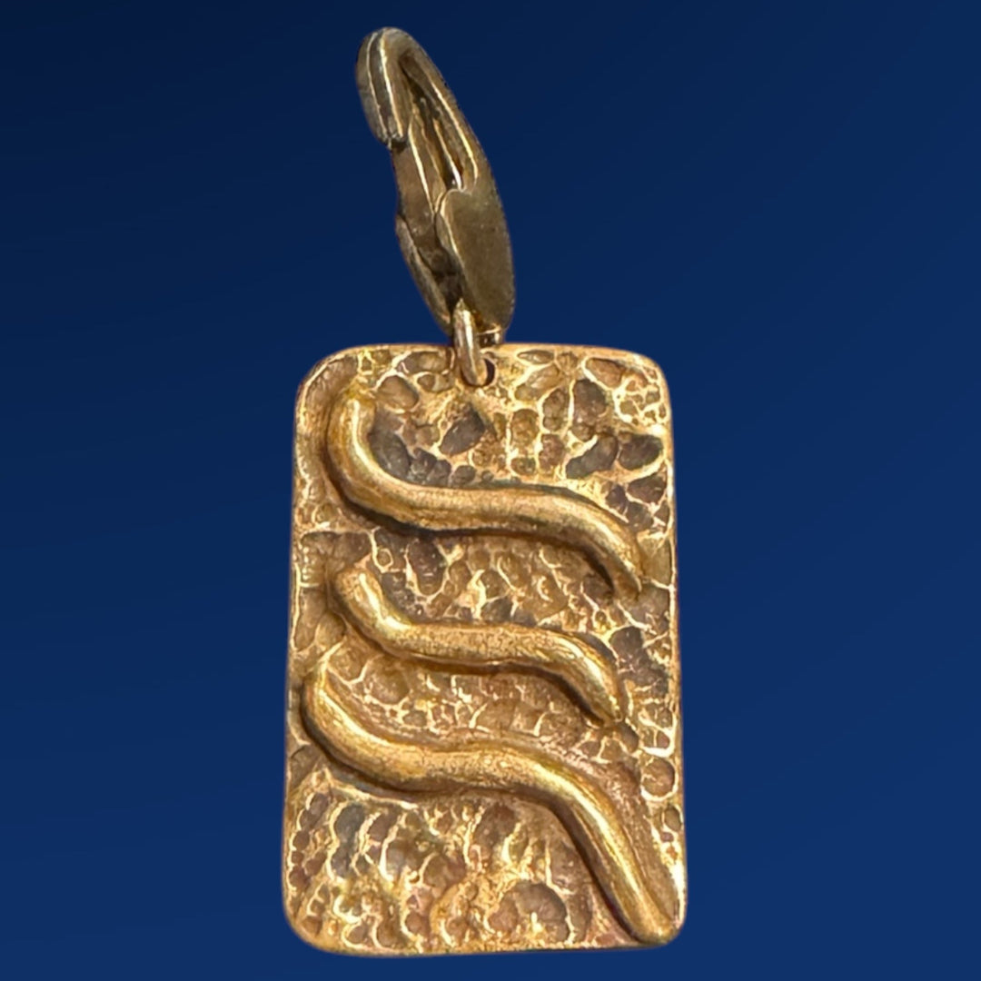 bronze tao air charm on blue background