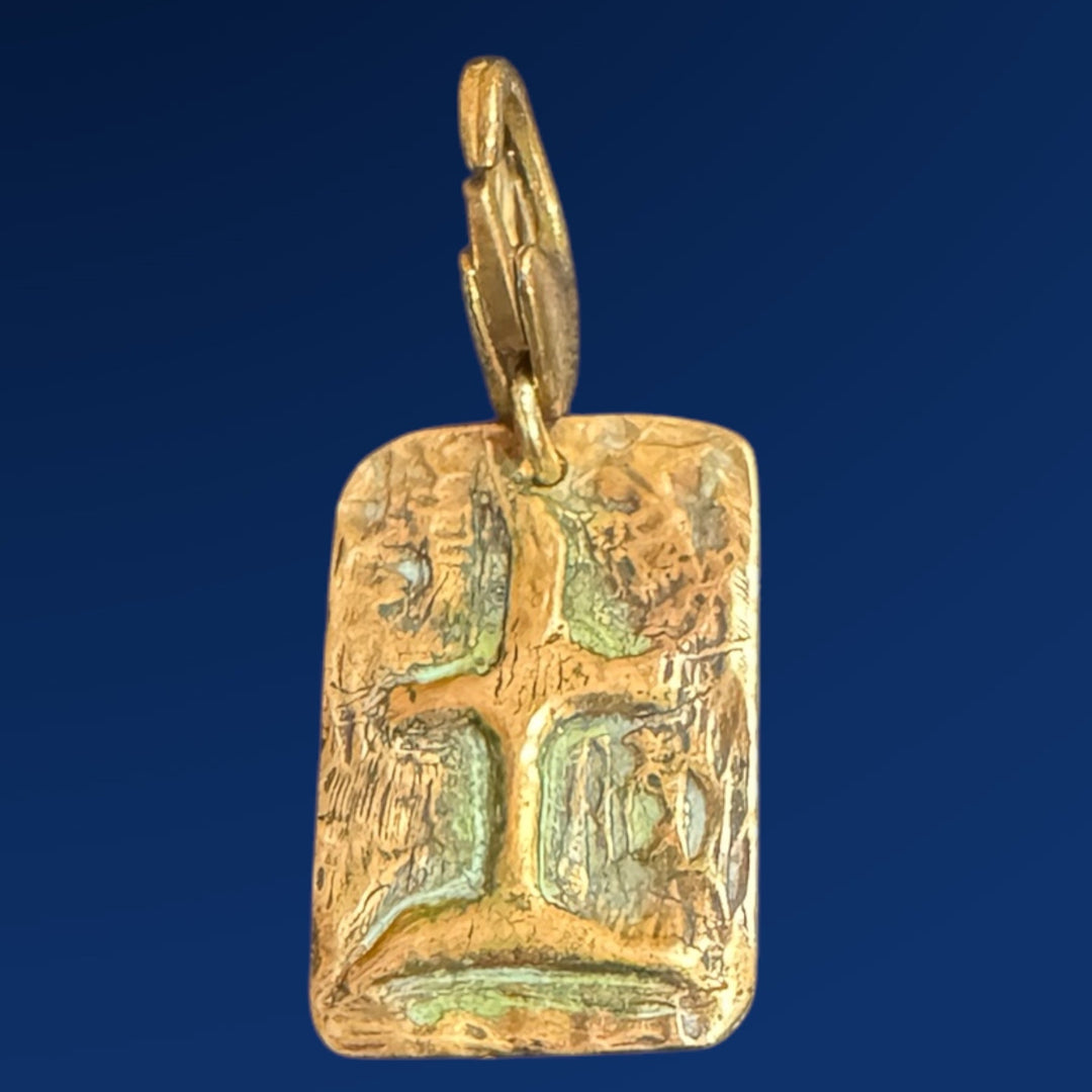 bronze tao earth charm on blue background