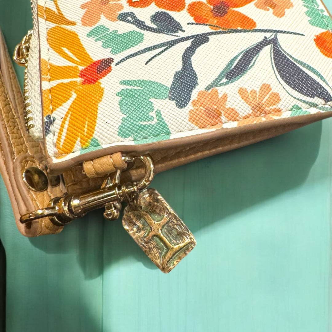 floral purse with tao earth charm on turquoise table