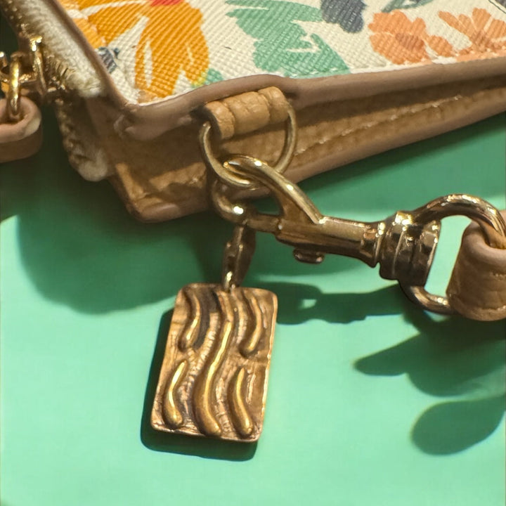 bronze tao element charm on floral purse