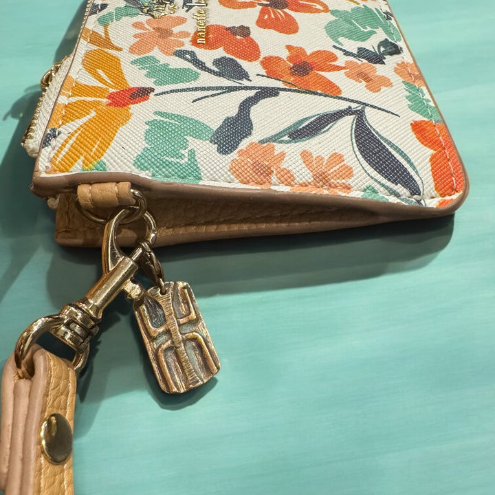 floral pattern purse with bronze tao wood clip on turquoise background