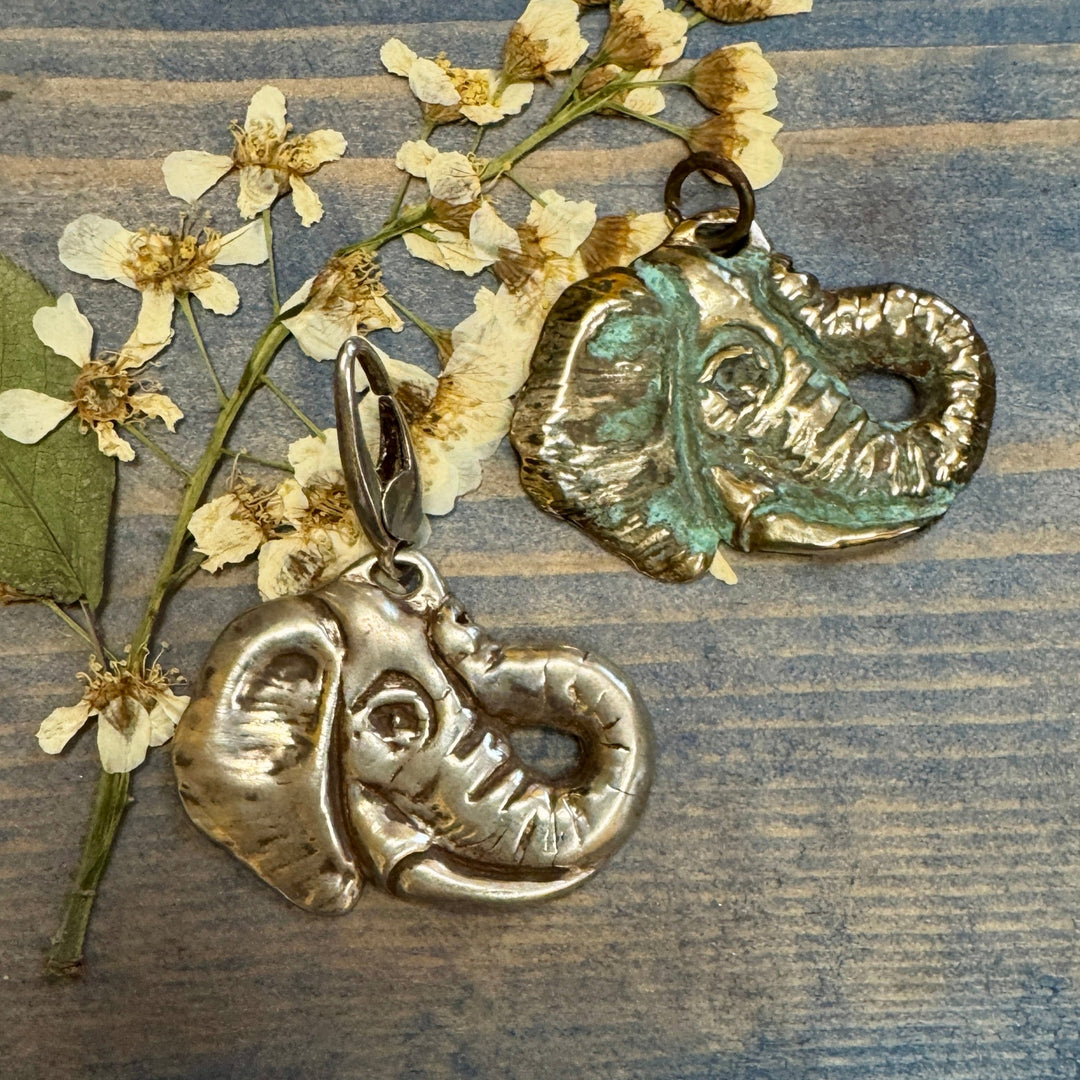 two elephant head charms on dried flower