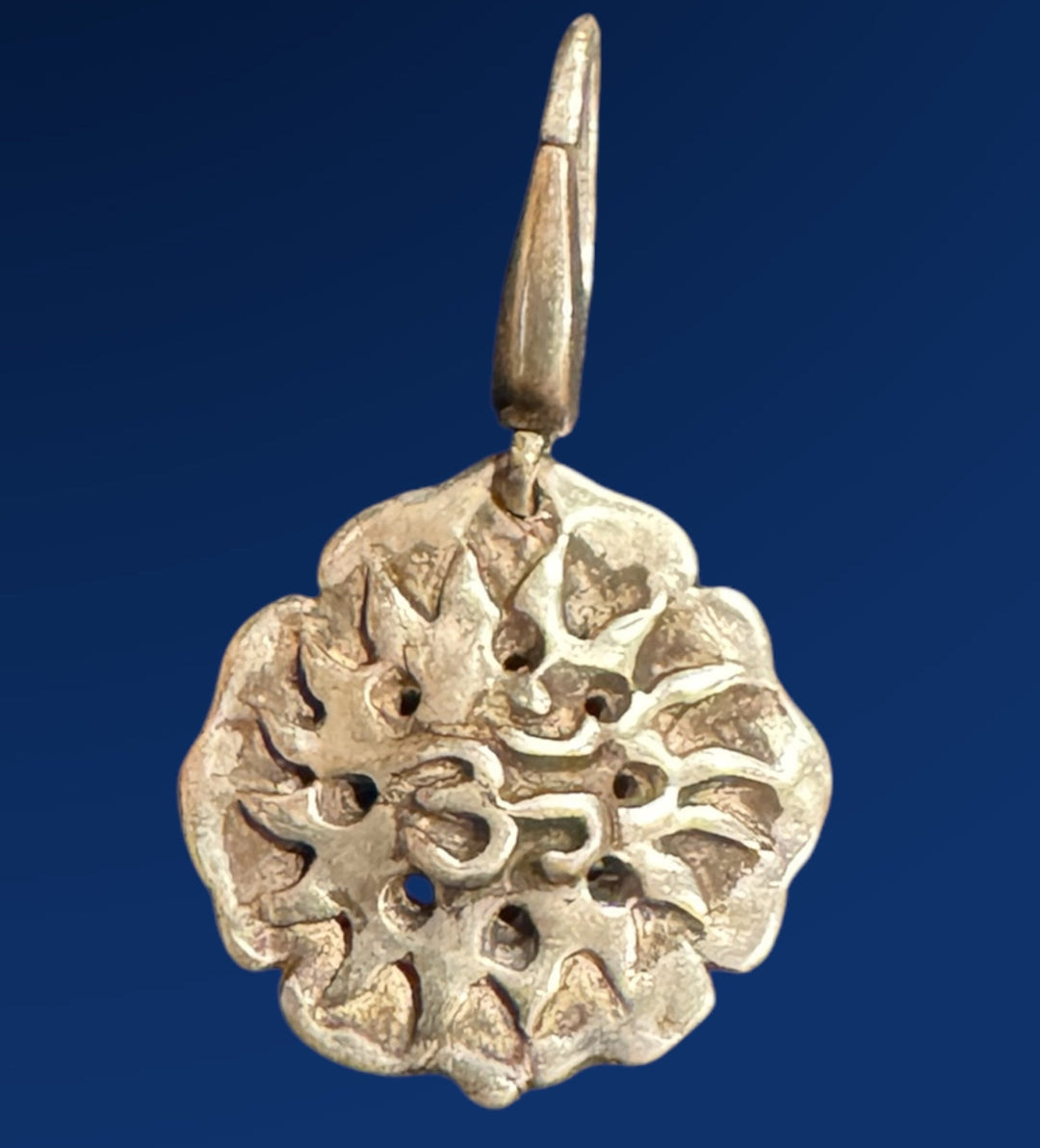 silver om lotus flower charm on blue background