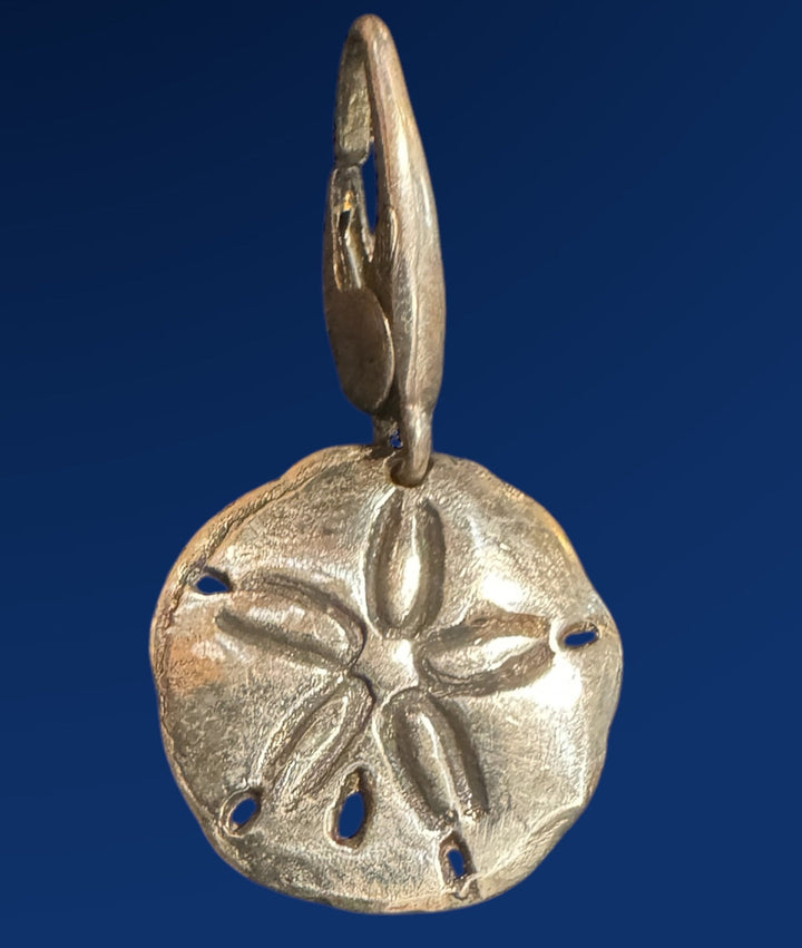 silver sand dollar pendant on a blue background