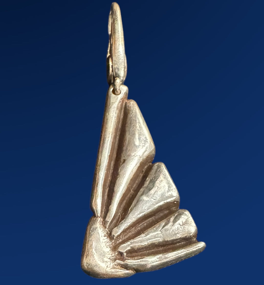 silver flower charm on blue background