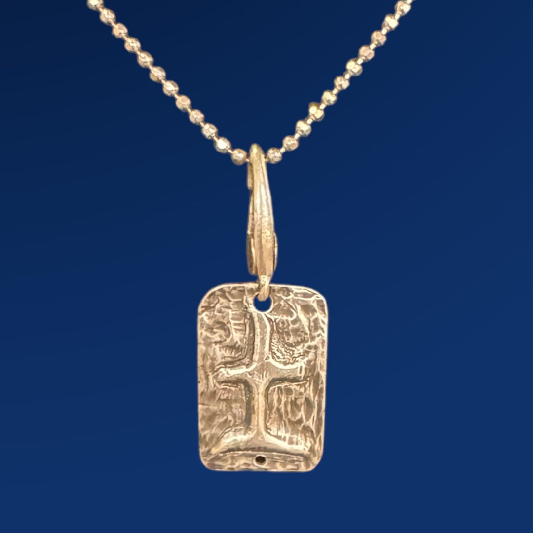 silver tao earth charm on ball chain and blue background