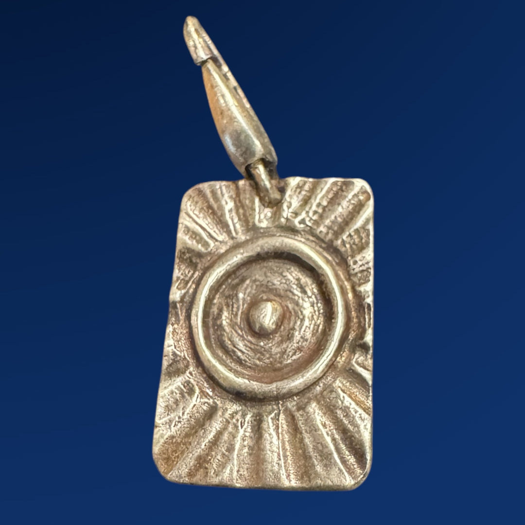 silver tao fire charm on blue background