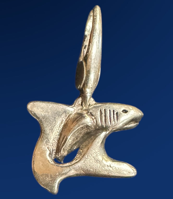 silver shark charm on blue background