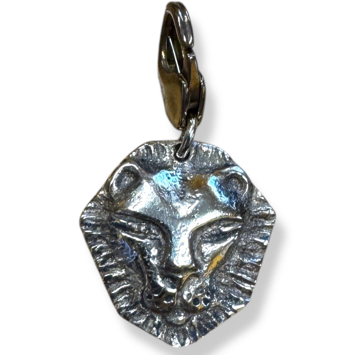 silver lion head charm on white background