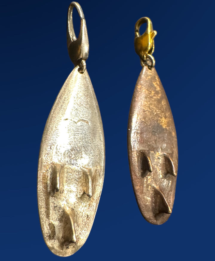 silver and bronze back of surfboard jewelry charm