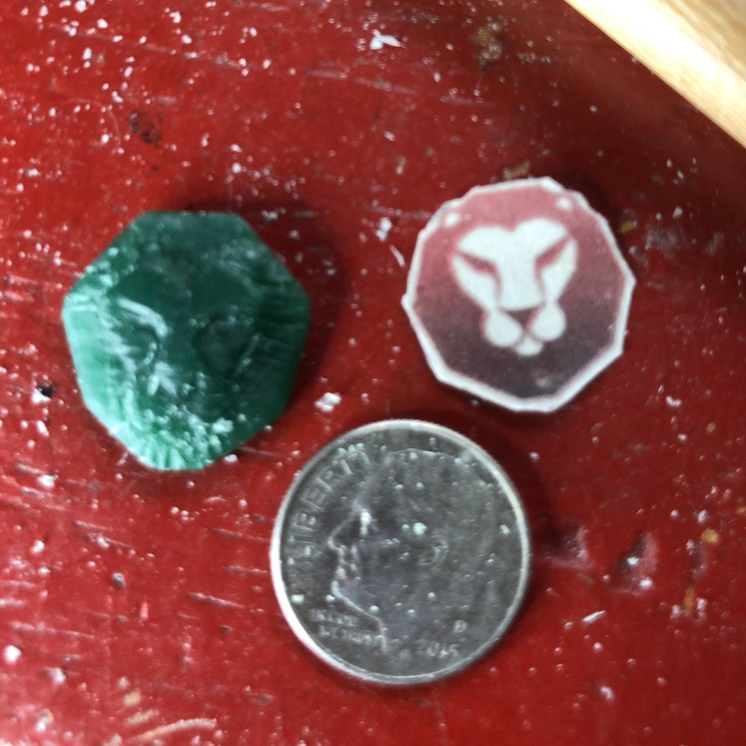 original wax carving of we walk as lions charm