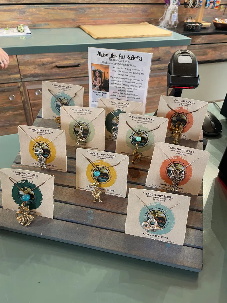 Table top display of busch wildlife necklaces on card stock