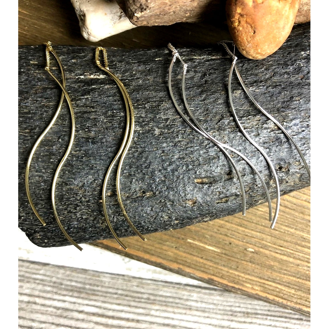 double helix threader earrings displayed on fossil bone in silver and gold
