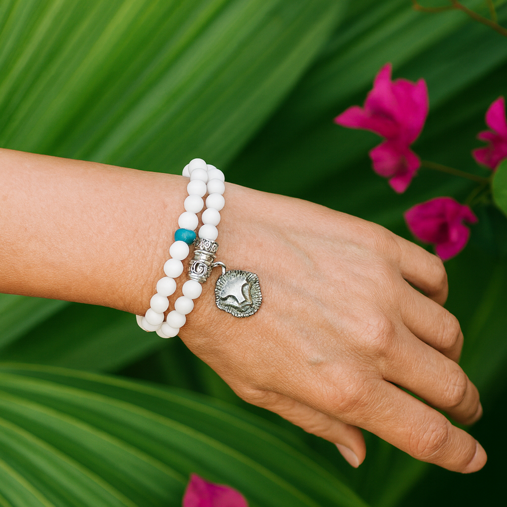Model wearing a white bronze shell bracelet with lion and turquoise 

