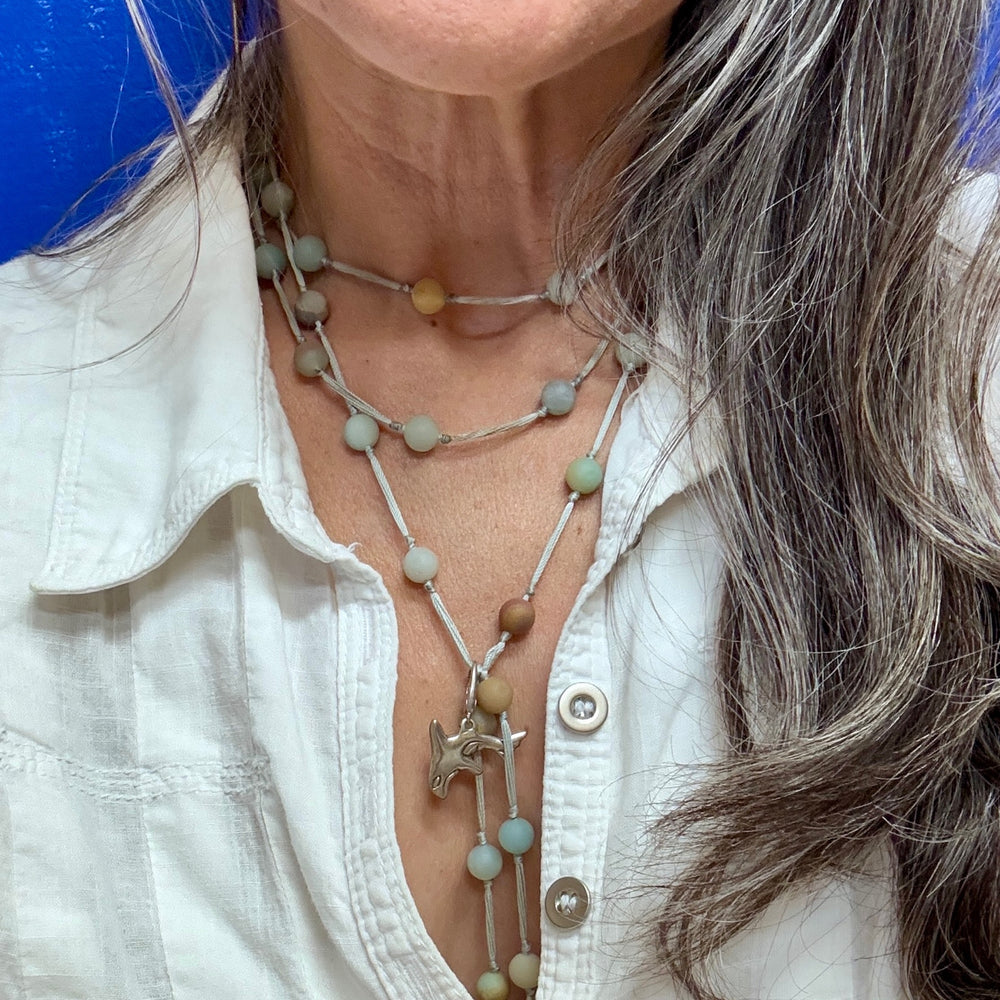 woman wearing backbeads with orca charm 