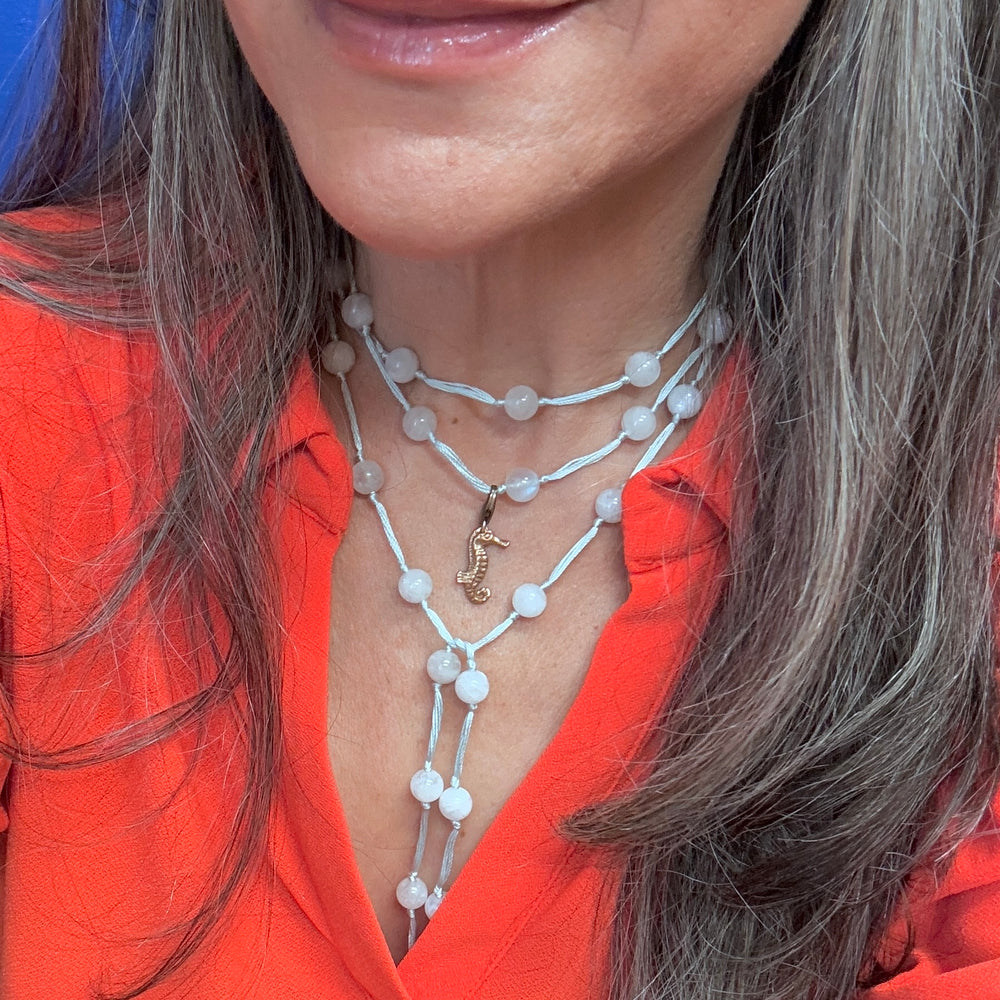 woman wearing moonstone layered backbeads with sea horse 