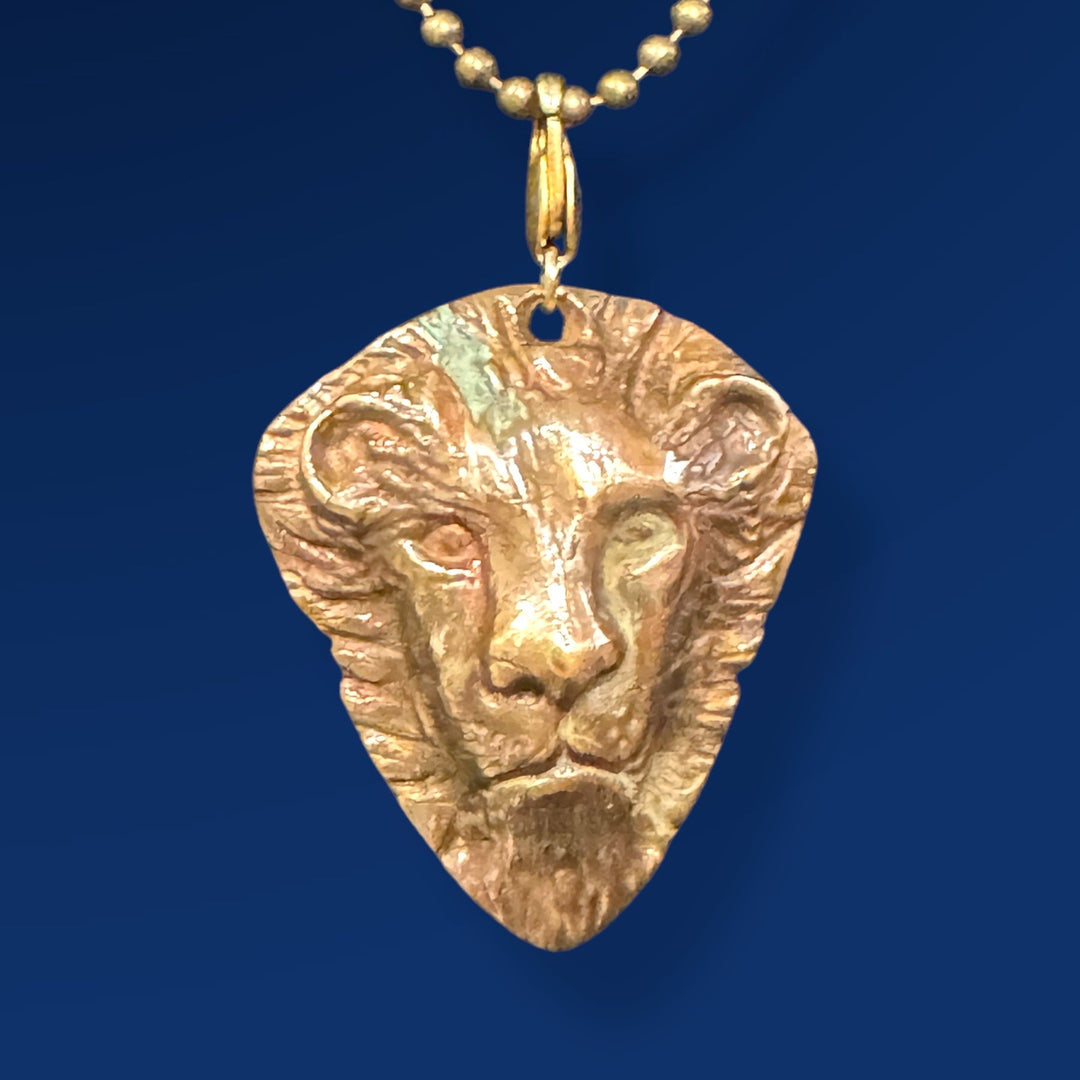gold pendant with lion head on chain

