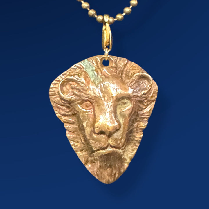 gold pendant with lion head on chain
